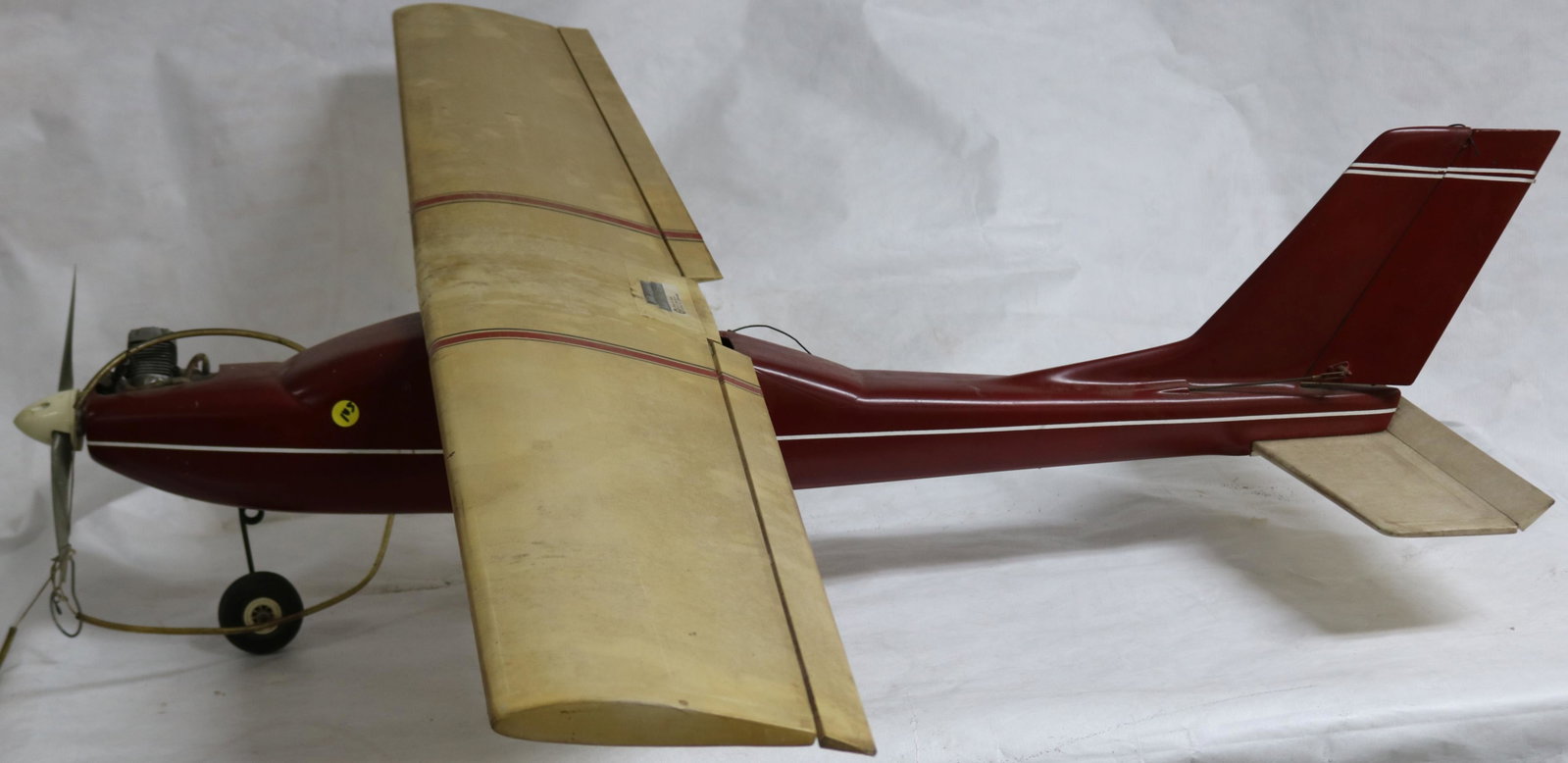 MODEL AIRPLANE, RED & WHITE WITH ENGINE &: CONTROLS, UNKNOWN WORKING CONDITION, APPEARS TO HAVE PARTS MISSING, 45 1/2" L, 57 1/2" WINGSPAN