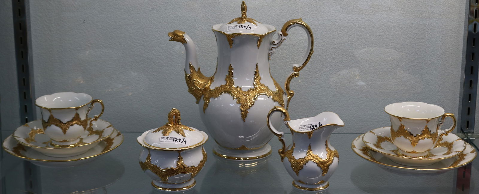 9 PC. MEISSEN'S CROSS SWORD TEA SET TO INCLUDE: 10" COFFEE POT WITH BIRD SPOUT, 4 1/2" SUGAR BOWL, 4 3/4" CREAMER, 7 3/4" DESSERT PLATE, 6 1/2" SAUCER, 3 3/4" DIA. CUPS, ORNATE GILT DESIGN