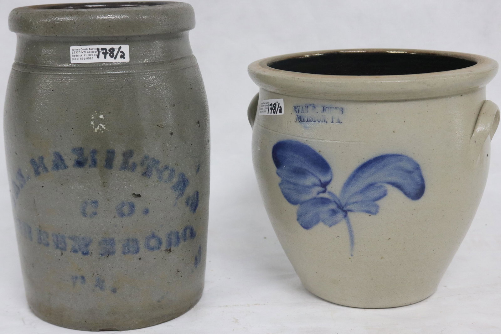 2 PENNSYLVANIA STONEWARE CRACKS, BLUE DECORATION: TO INCLUDE EVAN JONES PITTSTON PA, LEAF DESIGN, 8" H, 8 1/4" DIA. AND JOS. HAMILTON & CO. GREENSBORO PA, 10" H, 6 1/2" DIA., SMALLER CROCK SHOWS TINY CHIP TO INSIDE RIM