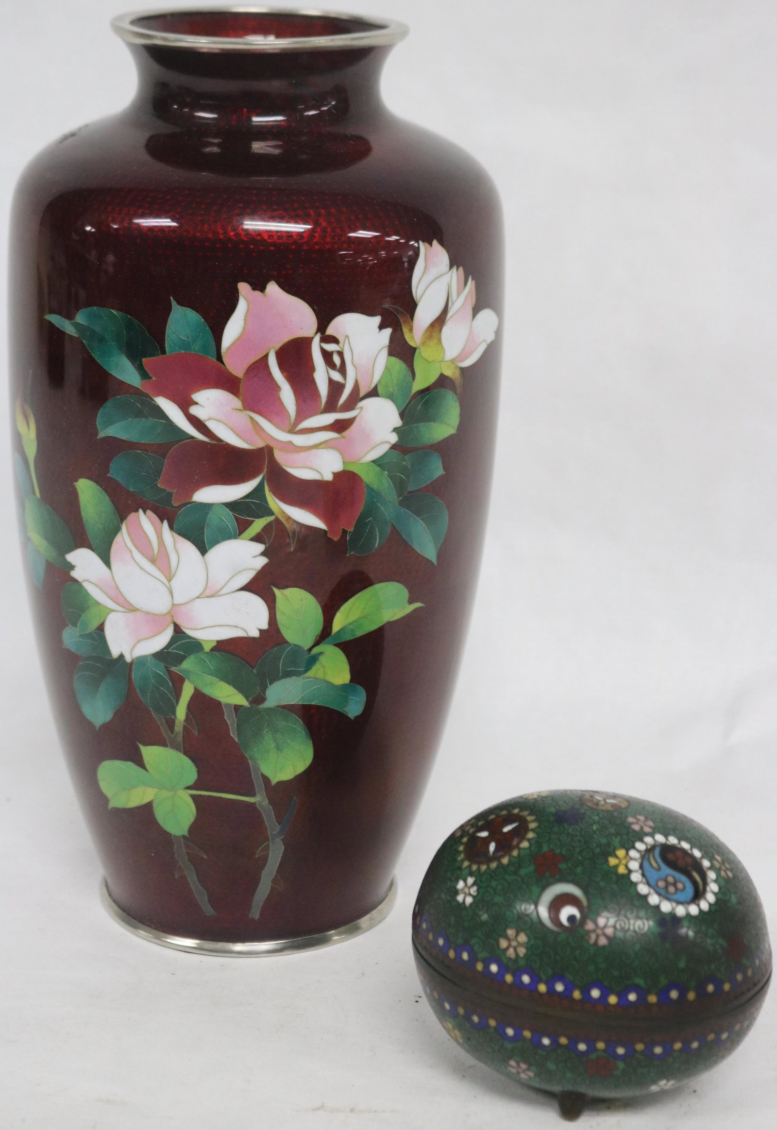 2 PCS. CLOISONNE TO INCLUDE MID 20TH C. 9 3/4" H: JAPANESE VASE, FLORAL DESIGN, FOIL BACKING, INSIDE SHOWS CRACK, TOGETHER WITH EARLY 20TH C. EGG SHAPED FOOTED COVERED BOX, ENAMEL MISSING TO INTERIOR, 3" H, CRACKING TO RIM OF VASE