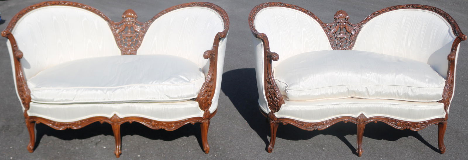 PAIR ORNATELY CARVED MAHOGANY SETTEES WITH CARVED: BIRDS, CORNUCOPIAS, FLOWERS ETC., LIKE NEW UPHOLSTERY, DOWN CUSHIONS, 32" H, 52 1/2" W, 29" D, SEAT HEIGHT 17"