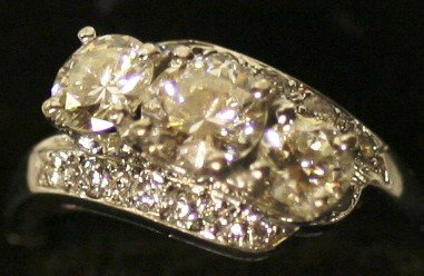 14K WHITE GOLD HINGED SETTING DIAMOND RING: WITH .75 CT CENTER STONE, FLANKED BY TWO .5 CT DIAMONDS, AND SEVERAL SMALL DIAMONS