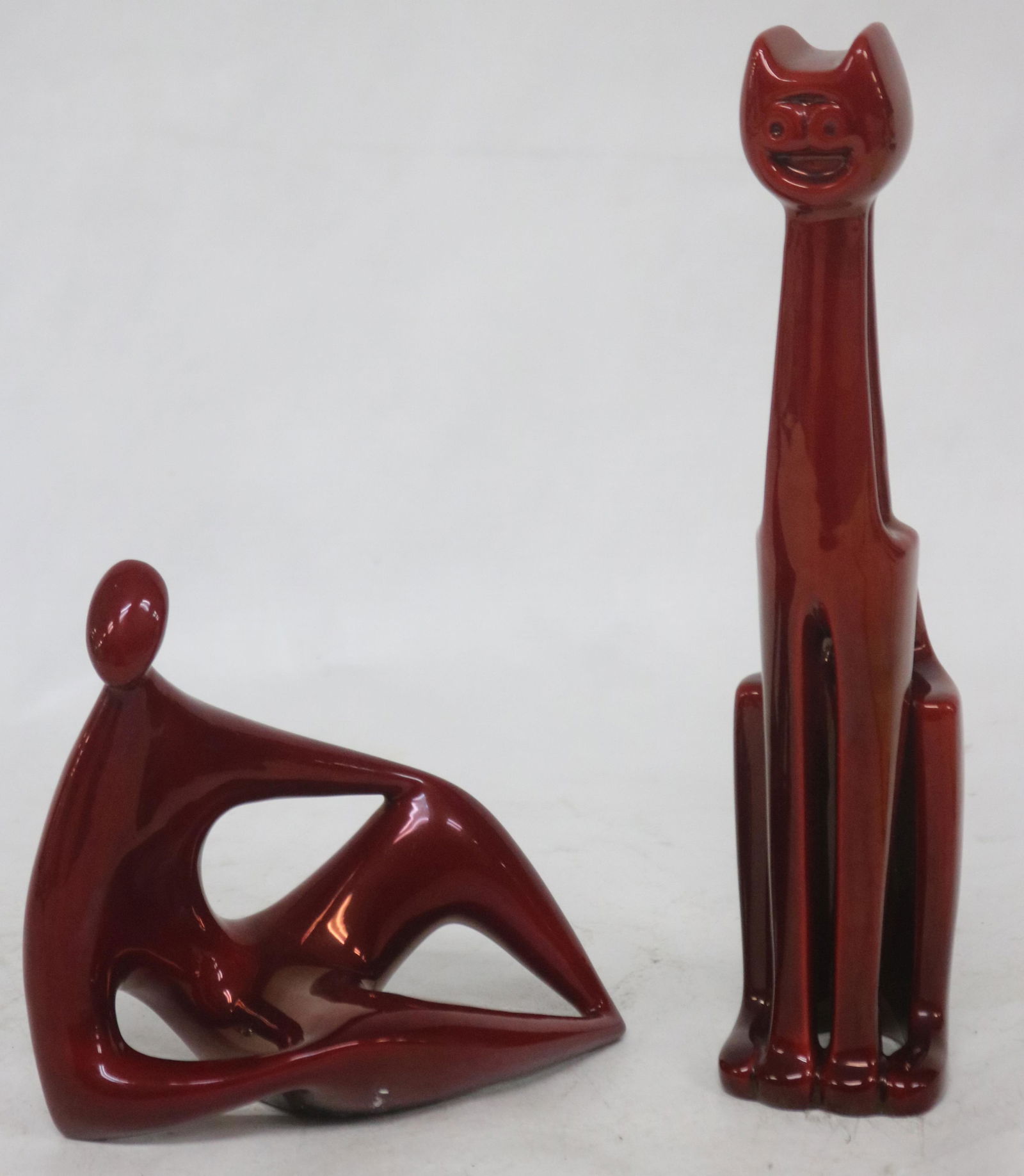 2 MID CENTURY MODERN STYLE ZSOLNAY FIGURES,: LAUGHING 9 1/4" H & SEATED HUMAN 5" H, IN UNUSUAL WINE COLOR