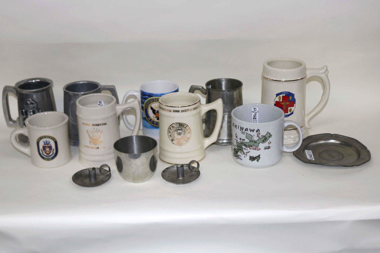 THIRTEEN MUGS & PEWTER: MILITARY RELATED IN PORCELAIN AND PEWTER, 3 1/2" TO 6 1/2" H.