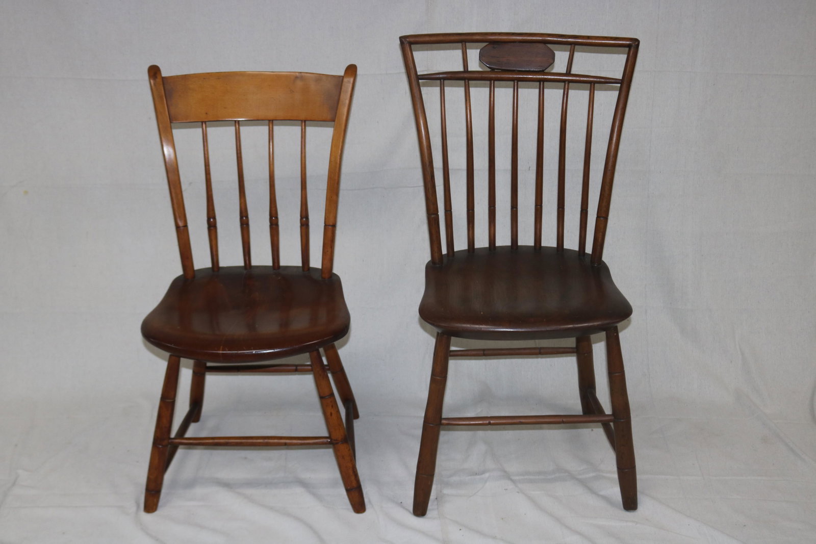 TWO 19TH CENTURY PLANK SEAT CHAIRS: INCLUDING A MEDALLION BACK WINDSOR AND A SPINDLE BACK, 31 1/2" TO 36" H. 16" W. 16" D. SEAT H. 15 1/2" TO 17 1/2".
