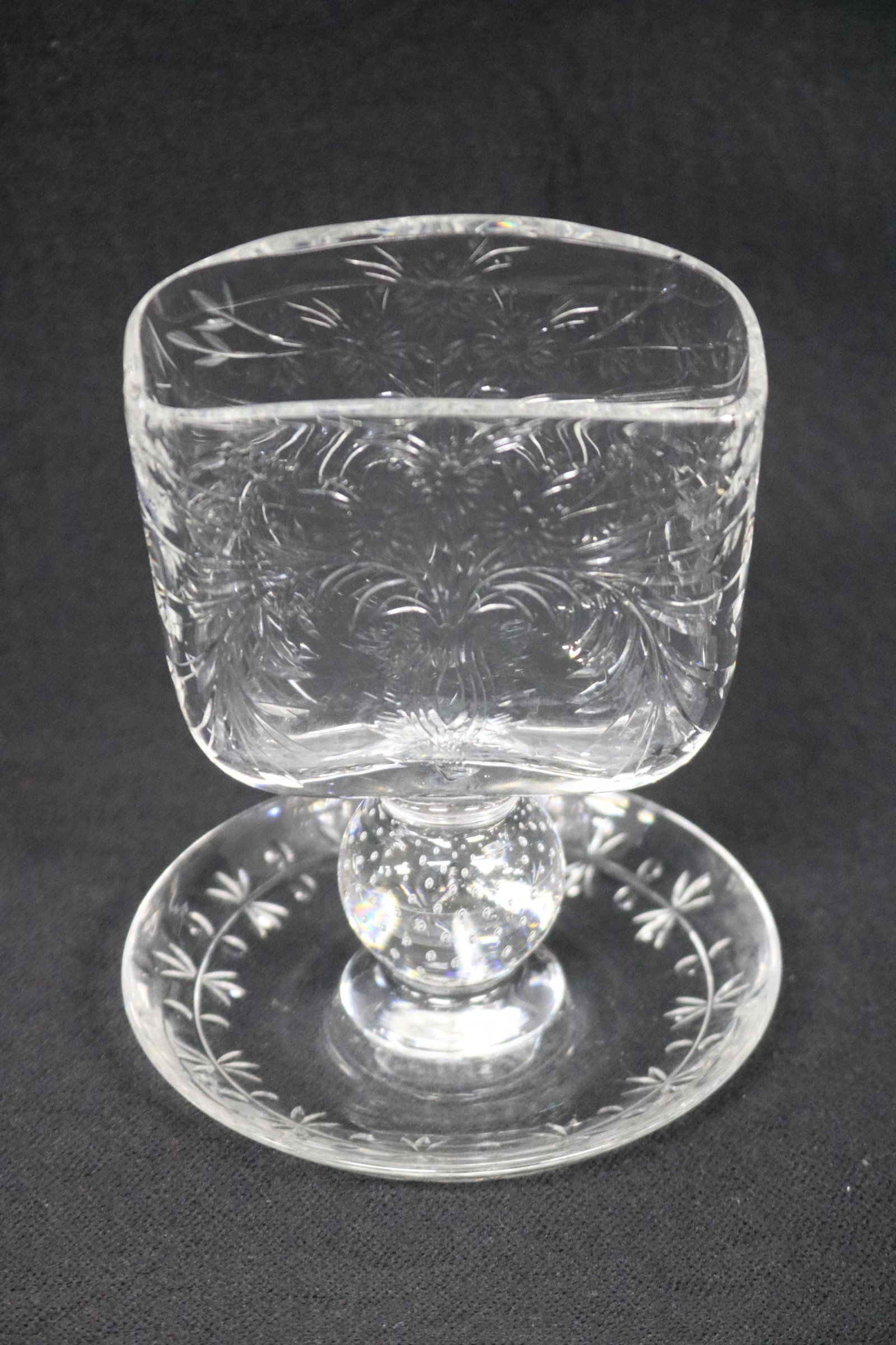 CLEAR GLASS MATCH HOLDER: ATTRIBUTED TO PAIRPOINT, FOLIATE IMPRESSED BASIN ON A BALL PLINTH AND DISH FORM BASE, UNSIGNED, 5" H,