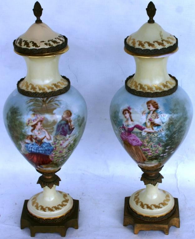 PAIR OF BRONZE MOUNTED LIMOGES PORCELAIN URNS,: WITH ROMANTIC SCENES, 17" H, BOTH COVERS SHOW REPAIRS