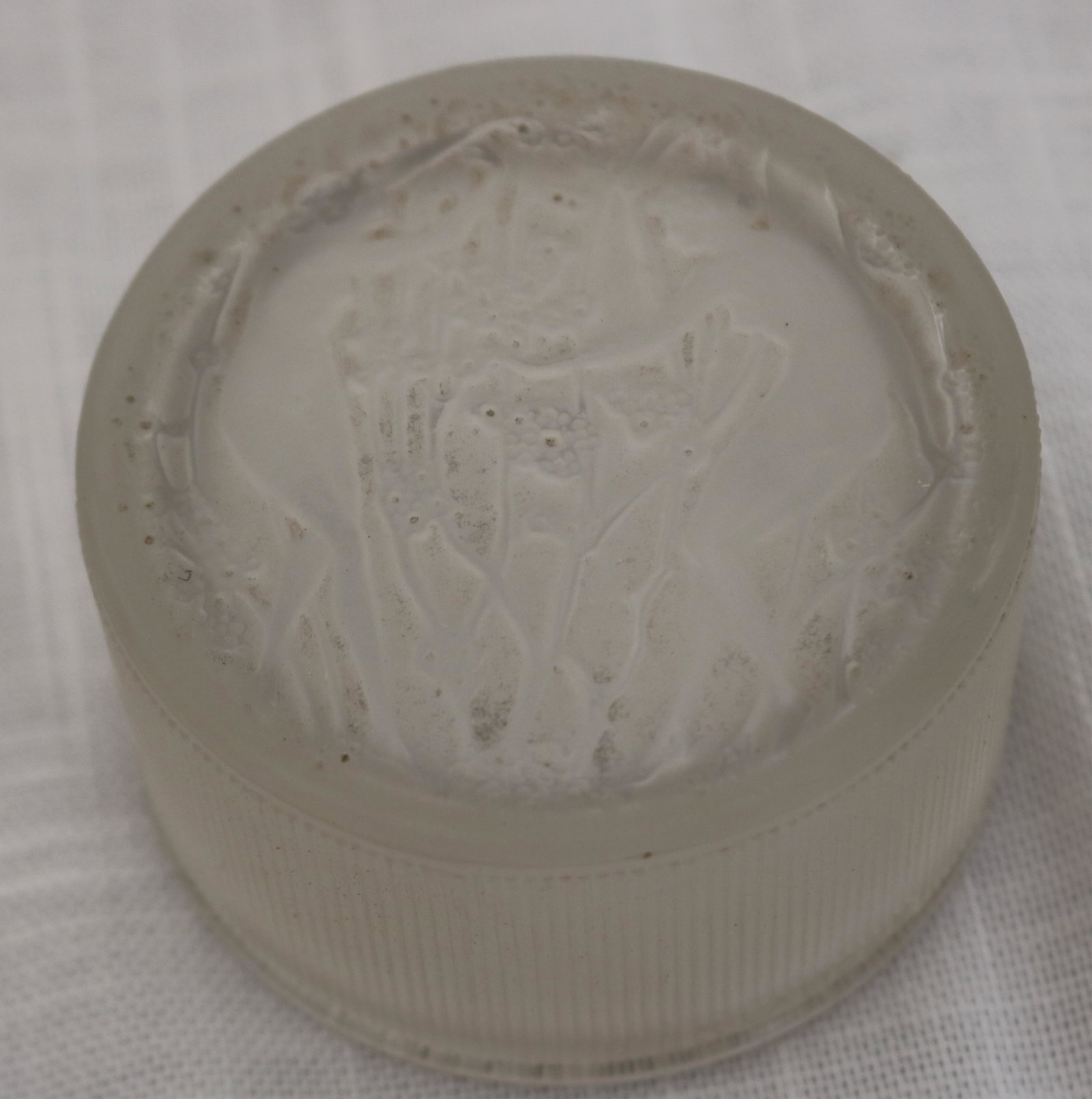 LALIQUE COVERED JAR, 2 NUDE WOMEN IN FOREST: SCENE, RIBBED SIDE, R. LALIQUE MARK ON SIDE, ETCHED FRANCE NO.'11 ON TOP AND BOTTOM RIM, 1 9/16" H, 2 3/4" DIA. NO DAMAGE