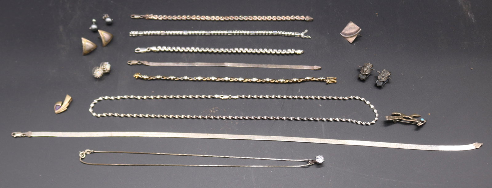 16 PCS. STERLING SILVER JEWELRY, 4 TENNIS: BRACELETS 7" - 8" L, NECKLACE WITH LARGE CZ 18" L, 18" L HERRING BONE & MATCHING 7 1/2" BRACELET, KINDS, PAIRS EARRINGS, PENDANT & PIN, 2.9 OZT.