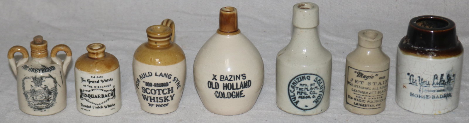 LOT 7 MINIATURE ADVERTISING JUGS & CROCKS, 1 WITH: BROKEN HANDLE