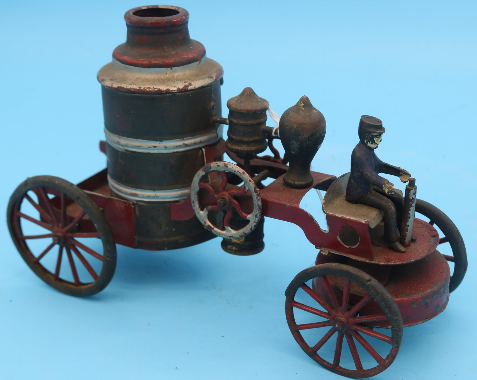 LATE 19TH C. PAINTED TIN FIRE PUMPER & STEERING: WHEEL, WIND UP MECHANISM WORKING, 6 1/2" H, 9 1/2" W, 4" D, THE OTHER 5" H, 6" W, 7" D, UNKNOWN WORKING CONDITION