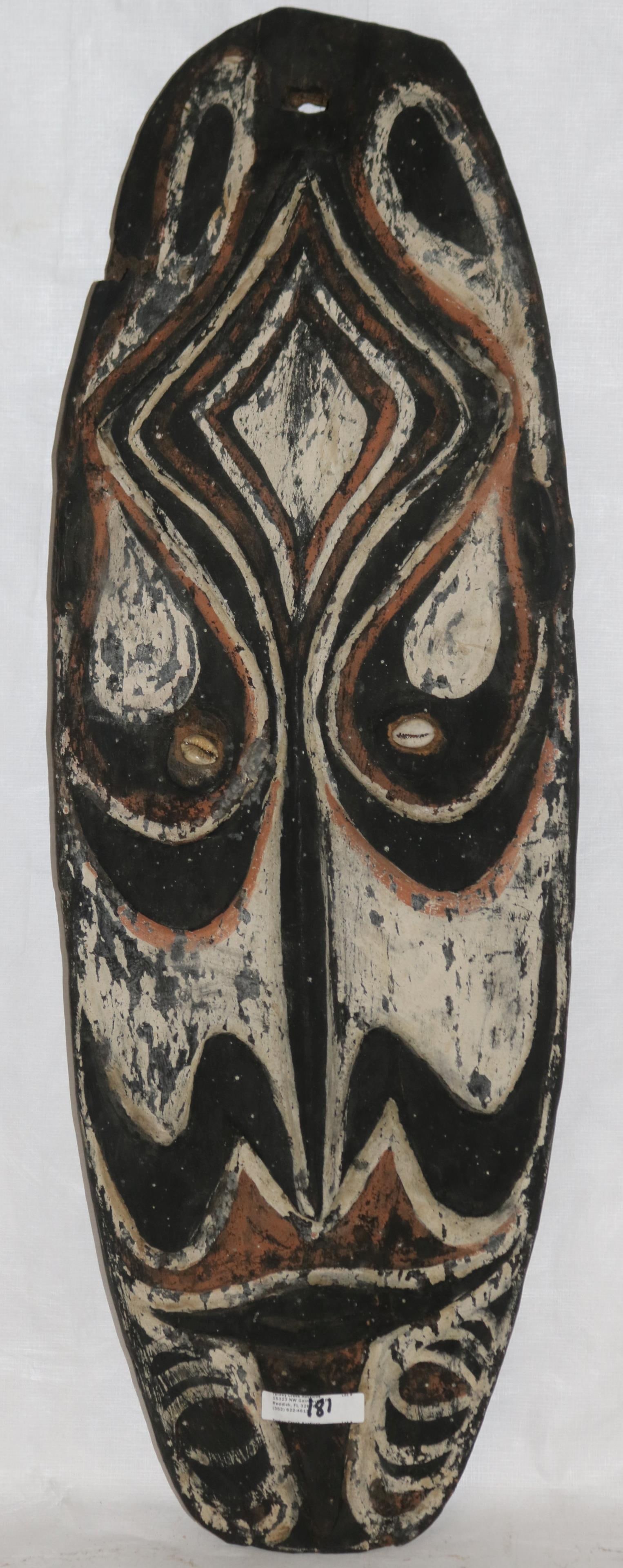 PAPUA NEW GUINEA CARVED & POLY CHROME PAINTED: STYLIZED FACE SHIELD, COWRIE SHELL EYE, 25 1/2" H, 8 3/4"