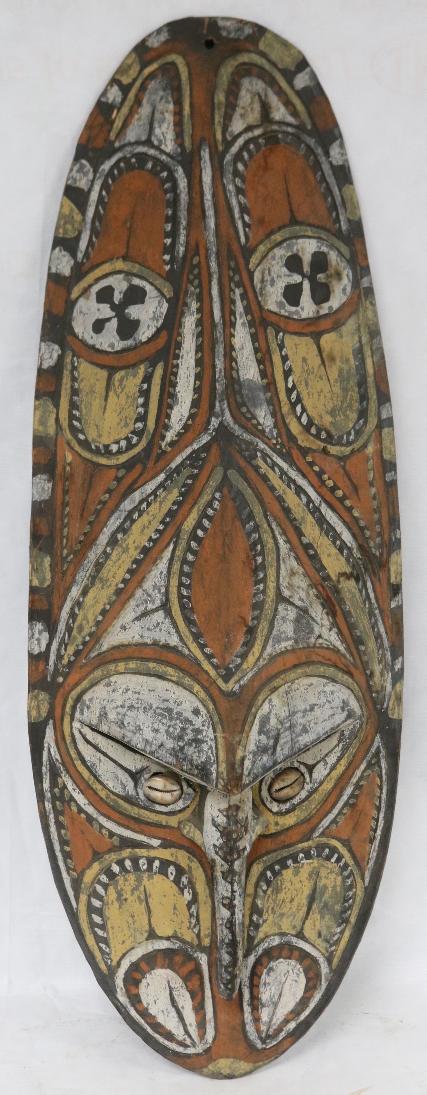 PAPUA NEW GUINEA CARVED & POLYCHROME PAINTED FACE: SHIELD, GEOMETRIC CARVED DESIGNS, COWRIE SHELL EYES, CARVED BACK, 29 3/4" H, 10 1/2" W