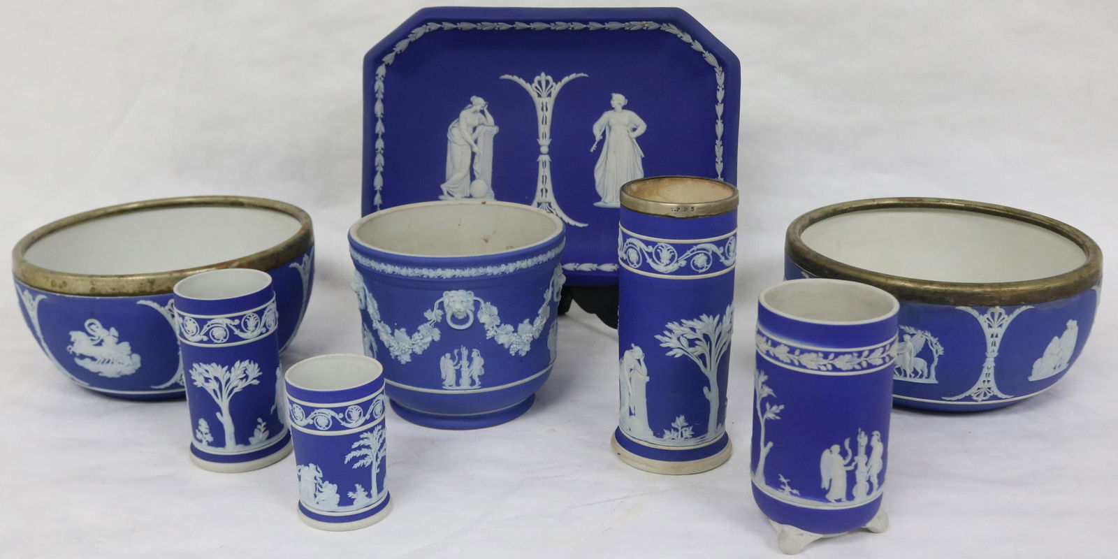 8 PCS. WEDGWOOD JASPERWARE, TWO 7 1/2" DIA. BOWLS: WITH METAL RIMS, 7 3/4" X 10 3/4" TRAY, 3" - 6" CYLINDER VASES, 4 1/2" H POT, LATE 19TH TO EARLY 20TH C., LARGE BOWLS SHOW MINOR HAIRLINE MARKS