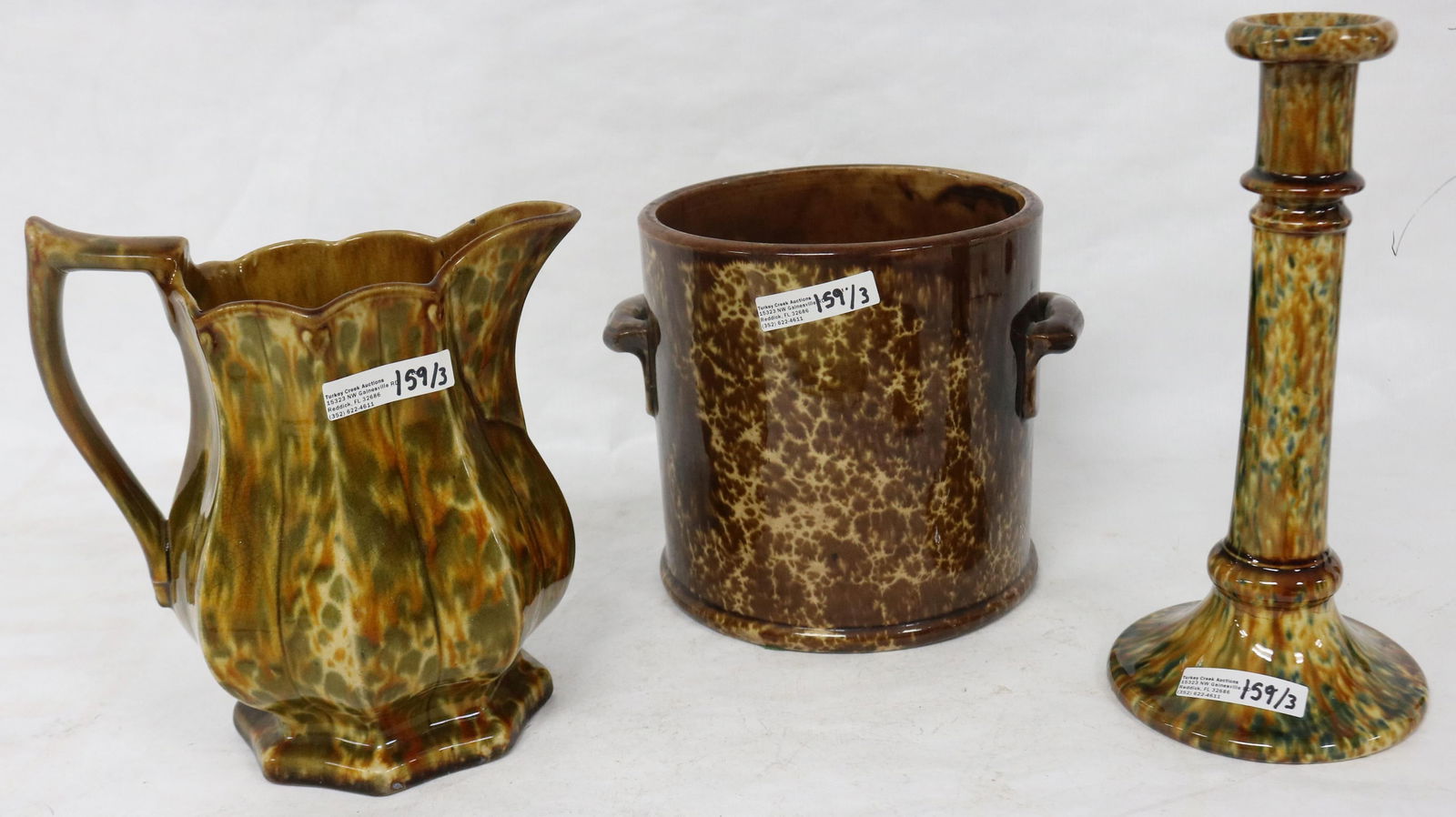 THREE 19TH C. ROCKINGHAM GLAZED ITEMS, 9 1/2": CANDLESTICK, 8" H PITCHER, 6 1/2" HANDLED CROCK, ALL IN GOOD CONDITION