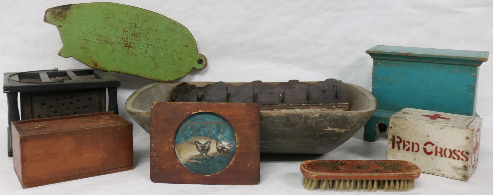 9 PCS. 19TH & 20TH C. WOODENWARE DOVETAILED SLIDE: LID BOX WITH OLD PAINT, 4" H, 8" W, TRENCHER HAS HOLE IN BASE, OLD PAINTED FINISH 5" H, 19 3/4" W, CAT PAINTING, 4 1/4" D, GREEN PAINTED PIG CUTTING BOARD 16" L, TIN & WOOD FOOT WARMER WITH INSERT, 6"