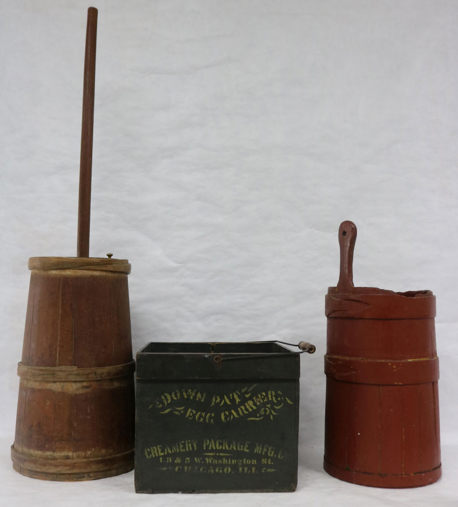 TWO EARLY 19TH C. WOODEN CHURNS, LAPPED WOOD: HOOPS, 1 WITH DASHER, 18" & POLE AND 21 1/2" H, RED PAINT, TOGETHER WITH WOODEN EGG CRATE "DOWN PATS EGG CARRIER" CHICAGO, 10 1/2" H, 12 1/4" X 13 1/2" ORIGINAL PAINT