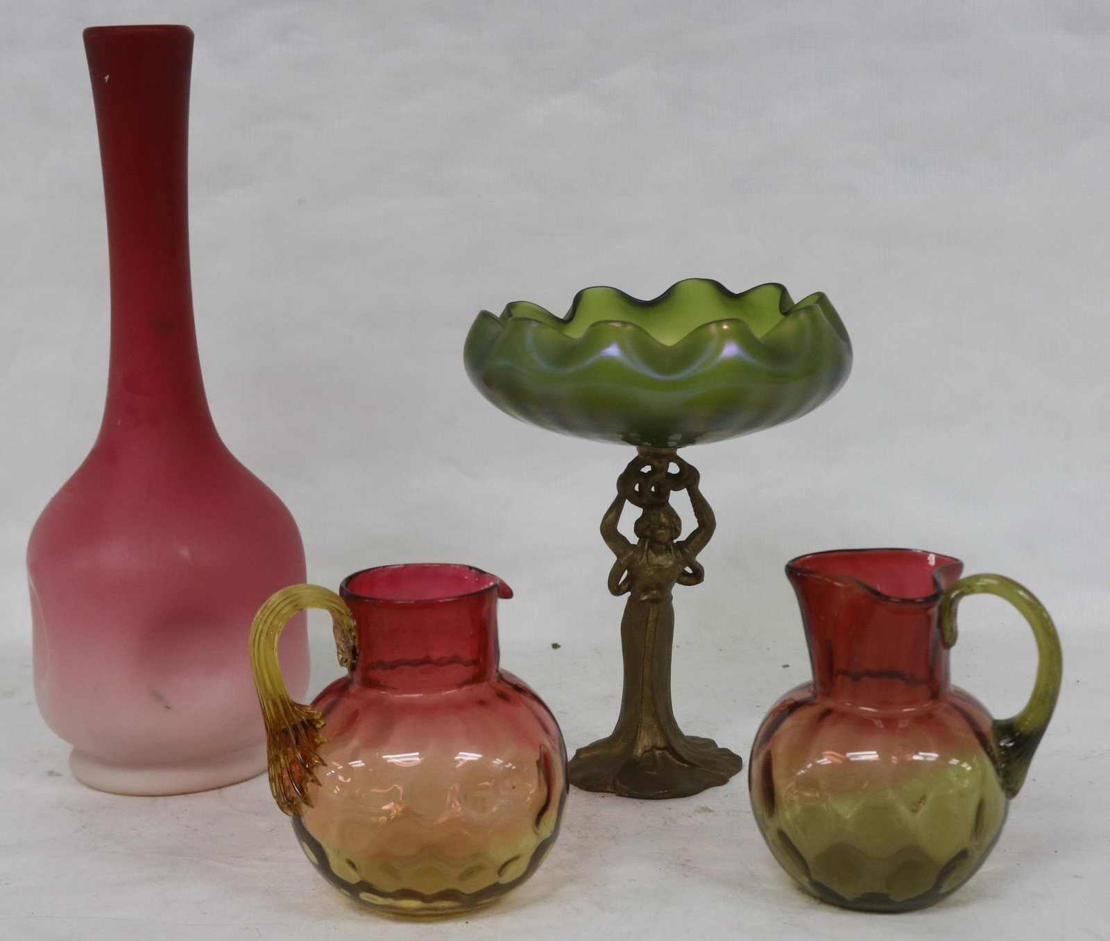 4 PCS. ART GLASS, AMBERINA PITCHER 4 3/4" H,: RUBINA VERDE PITCHER 5" H, PEACH BLO PINCH VASE 12 1/2" H, CZECH GLASS COMPOTE WITH FIGURAL METAL BASE, 8" H, 6 1/2" DIA., RUFFLE TOP, STANDING FEMALE BASE, MINOR ROUGHAGE TO BASE OF BOWL