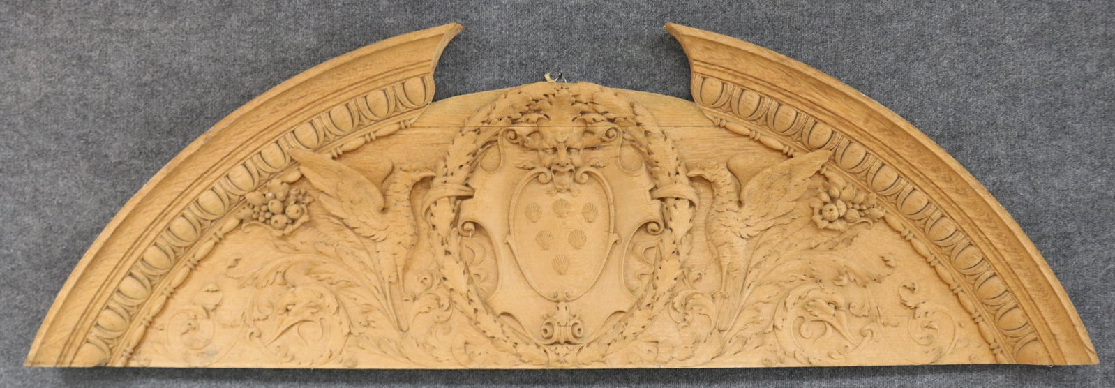 LATE 19TH C. ORNATELY CARVED OAK ARCH, WINGED: GRIFFINS, NORTH WIND HEAD, WREATH CREST, FRUIT & OTHER CARVING, NATURAL FINISH, 23" H, 72 1/2" W, 2 1/2" D