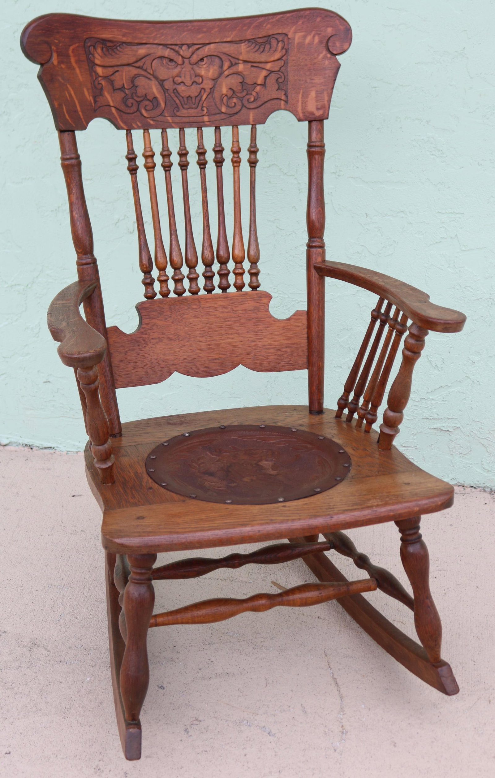 VICTORIAN OAK ROCKER, PRESS BACK WITH LION HEAD,: SPINDLE BACK & ARMS, PRESSED LEATHER SEAT WITH LION HEAD, REFINISHED CONDITION, 41" H, 24 1/2" W, 32 1/2" D