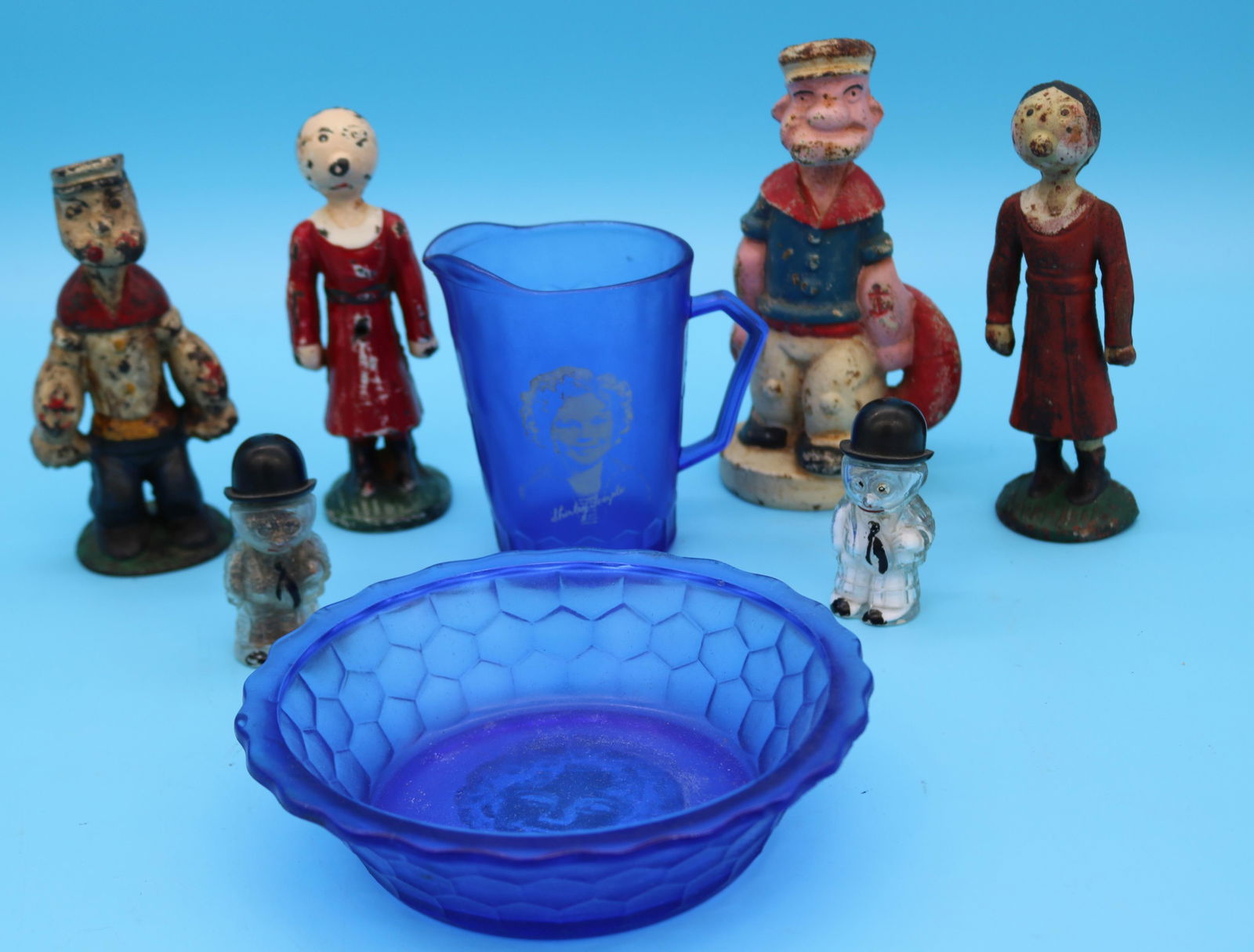 LOT 8 CHARACTER ITEMS, 2 CAST IRON POPEYE FIGURES: 1 WITH PHILIPS SCREW 6" & 6 3/4" H, 2 OLIVE OIL CAST IRON 6" H, BARNEY GOOGLE S&P 3" H, SHIRLEY TEMPLE CREAMER 4 1/2" H, BOWL 6 1/2" DIA.