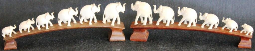 TWO CARVED IVORY ELEPHANT BRIDGES,: EACH WITH 6 ELEPHANTS, SOME SHOW DAMAGE TO TRUNKS & TUSKS, 3 1/2" H, 10 1/2" L, SHIPPING RESTRICTED WHERE LOCAL LAWS PROHIBIT