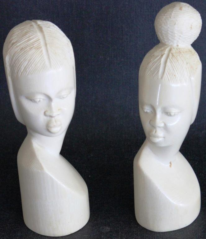 TWO CARVED IVORY BUSTS OF AFRICAN WOMEN,: 7 1/2" H, SHIPPING RESTRICTED WHERE LOCAL LAWS PROHIBIT