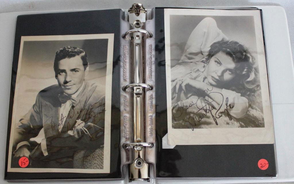 ALBUM WITH 31 AUTOGRAPHED PHOTOS OF CELEBRITIES: TO INCLUDE, BETTY GRABLE, ART BUCHWALD, LINDA EVANS, ED ASNER, BING CROSBY, PAUL HOGAN, ETC.