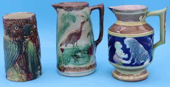 THREE 19TH C. MAJOLICA PITCHERS, BABY WITH DOG,