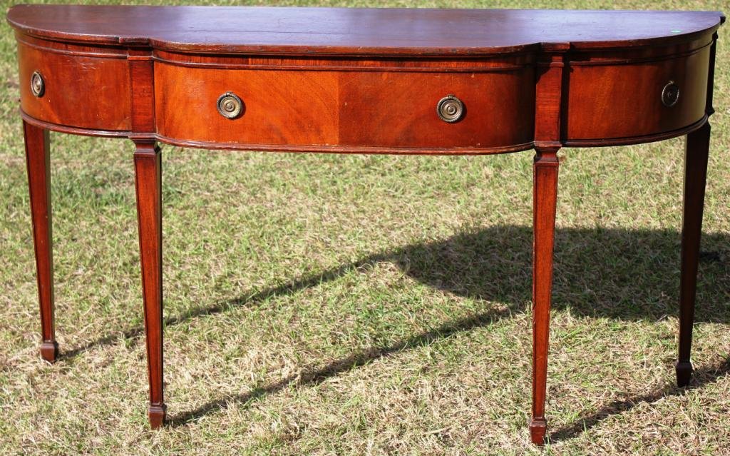 CUSTOM MAHOGANY HEPPLEWHITE STYLE CONSOLE TABLE,: WITH SHAPED FRONT, BRASS HARDWARE CENTER DRAWER WITH TWO COVERED DOORS, SHOWS SOME WEAR, 33" H, 60" W, 19 3/4" D