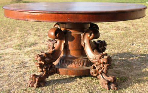 EXCEPTIONAL ROUND OAK TABLE,: QUARTERED OAK, WITH HEAVILY CARVED, GARGOYLE HEAD & CLAW FOOT BASE, SPLIT PEDESTAL, TWO LEAVES, 29" H, 54" DIA.