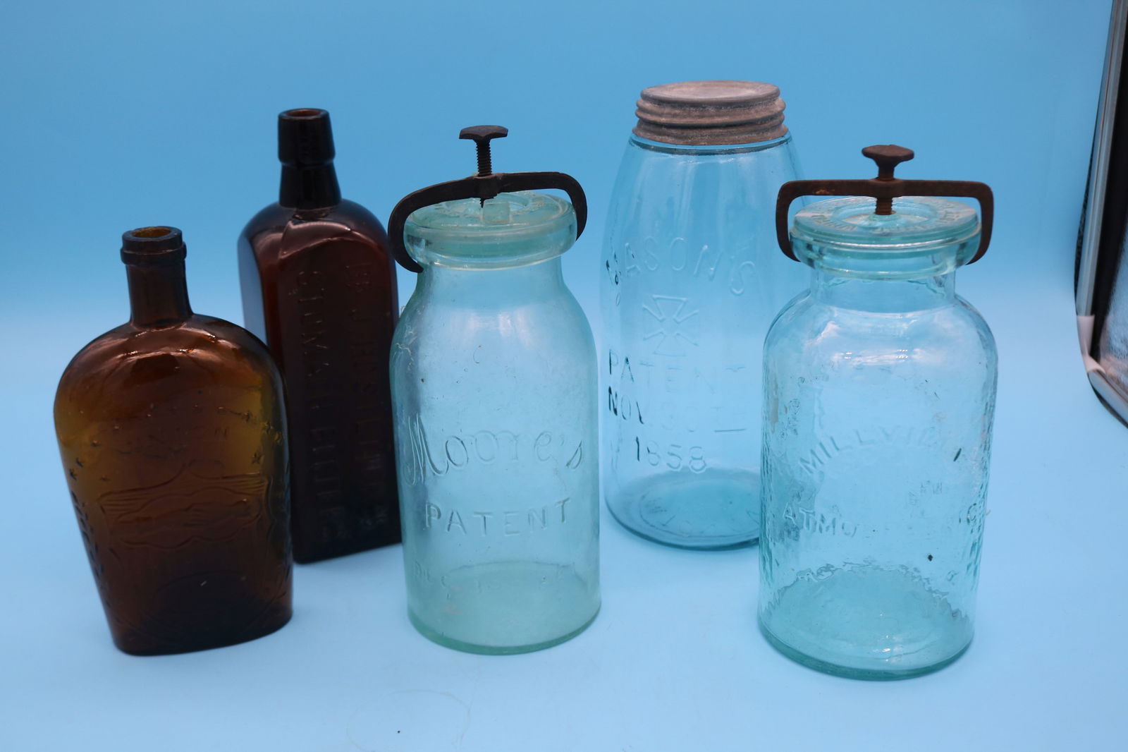 LOT OF (5) 19TH C. BOTTLES, AMBER CLASP HANDS &: EAGLE FLASK, 7 3/4" H, DR J. HOSTETTOR'S STOMACH BITTERS, 8 3/4" H, MILLVILLE ATMOSPHERIC FRUIT JAR 1861 9" H, GREAT WHITTLE MOORE'S PATENT 1861 9 1/4" H, MASONS PATENT 1858 9" H, MINOR ROUGHAGE TO FL