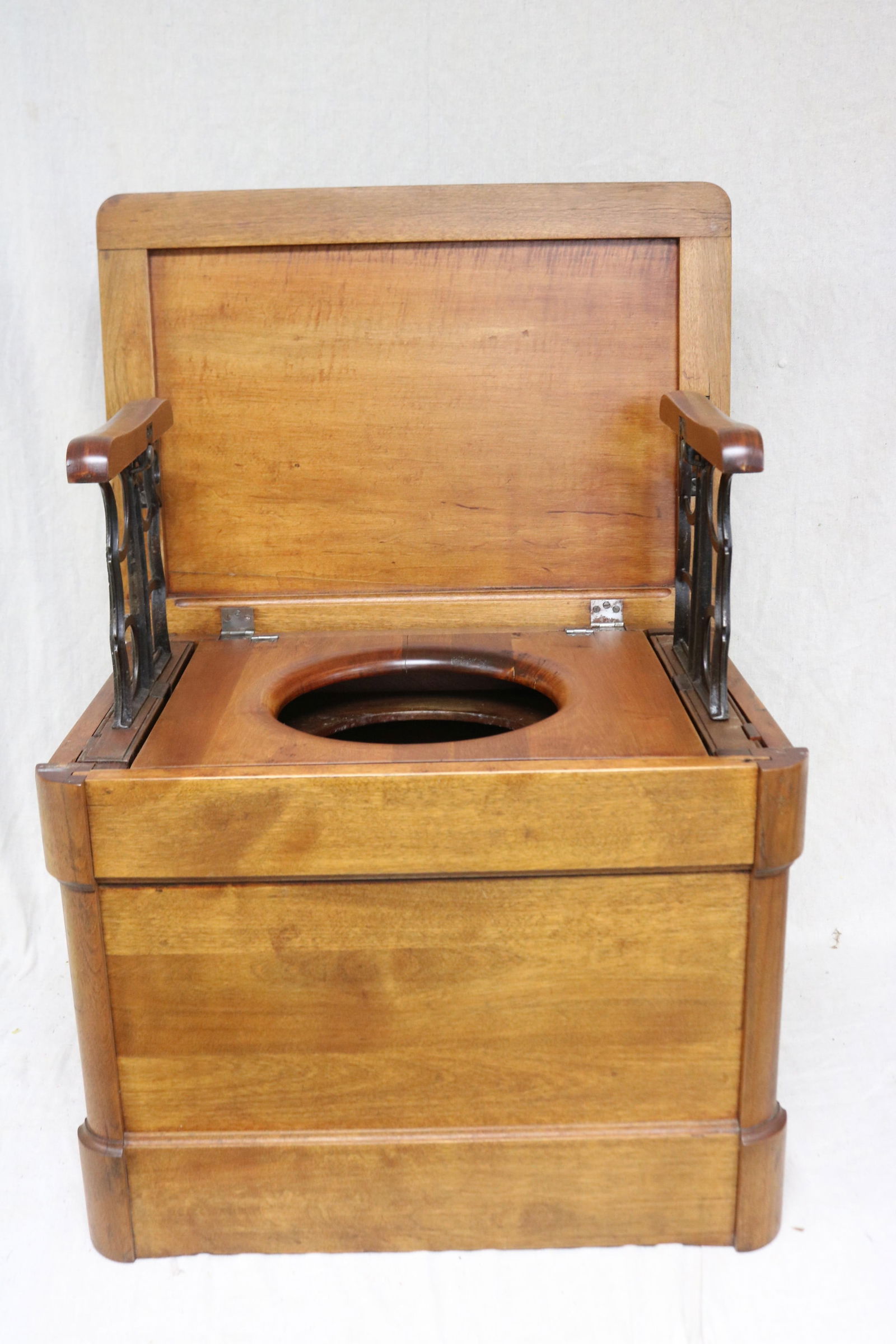 19TH C. POTTY CHAIR, WALNUT & MAPLE, LIFT TOP: WITH RETRACTABLE CAST IRON ARM, REFINISHED CONDITION, NO POT, GOOD CONDITION, 17" H, 22 1/2" W, 16 1/2" D, 32" OPEN