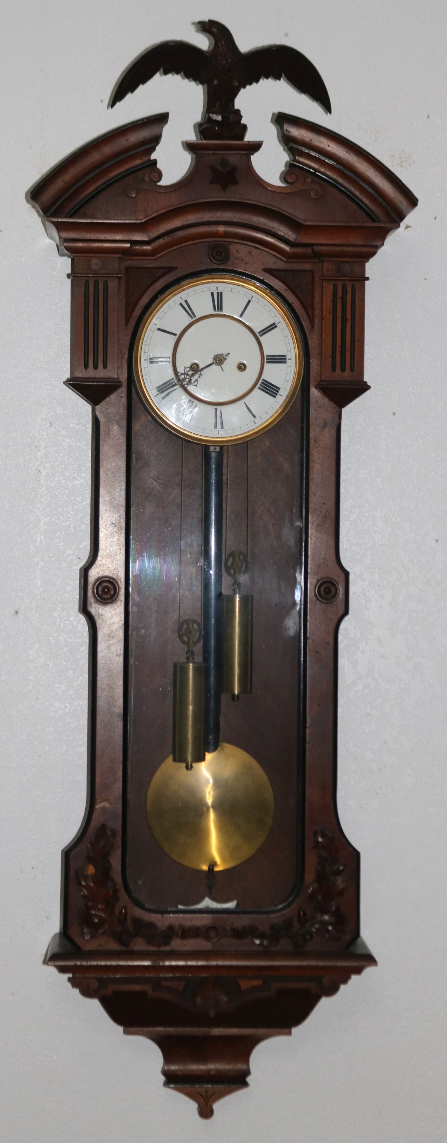 VICTORIAN WALNUT WALL REGULATOR CLOCK, WEIGHT: DRIVEN, TIME & STRIKE, CARVED EAGLE FINIAL, OLD FINISH, ENAMELED DIAL, 48" H, 17 1/4" W, 7 1/2" D