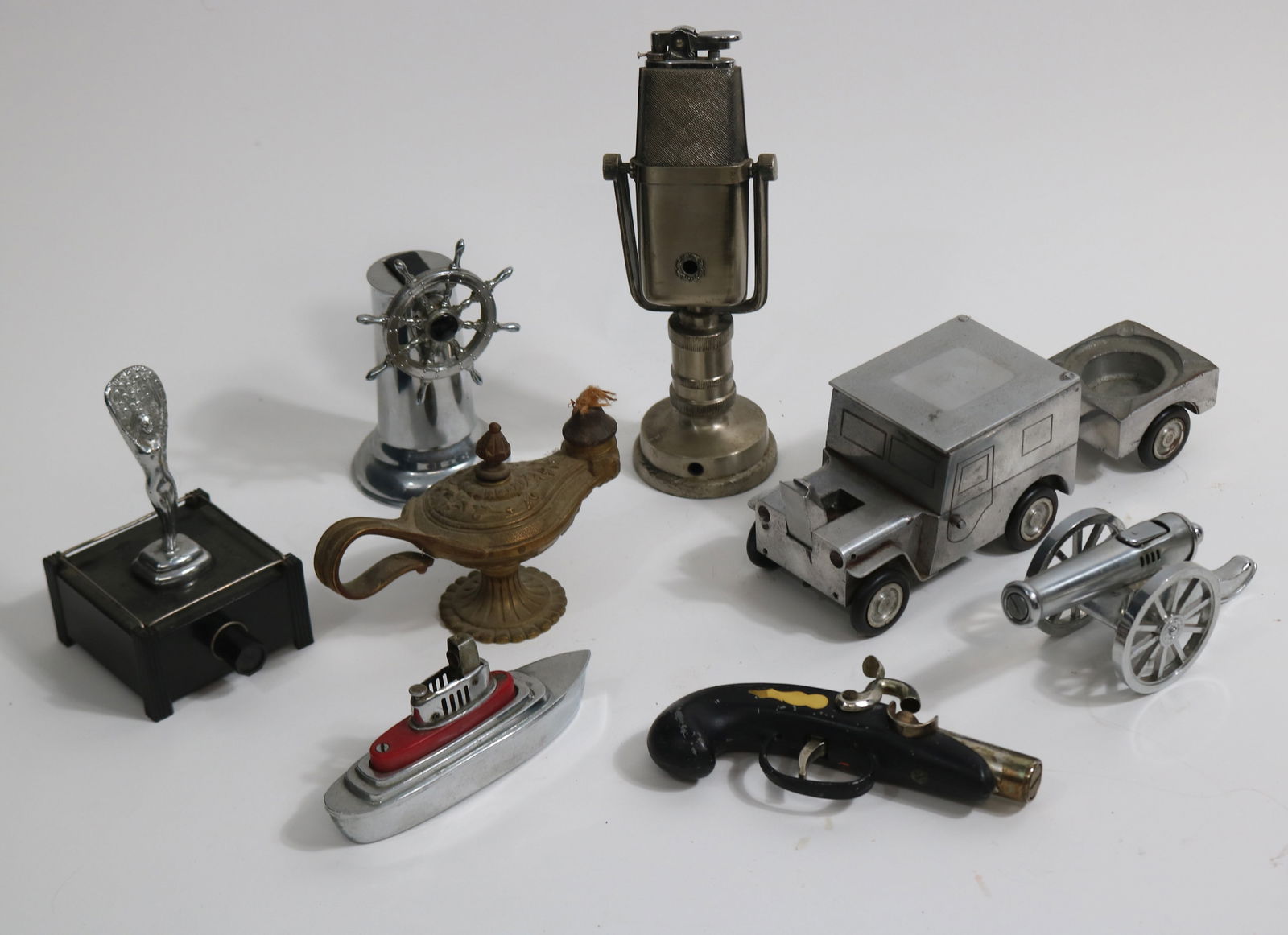 COLLECTION OF 8 METAL FIGURAL LIGHTERS, JEEP WITH: ASH TRAY TRAILER, MICROPHONE, SHIP, SHIPS WHEEL, CANNON, FLINT LOCK PISTOL, BRASS GENIE LAMP, ART DECO LADY, 2" - 8 3/4" H, GOOD OVERALL CONDITION