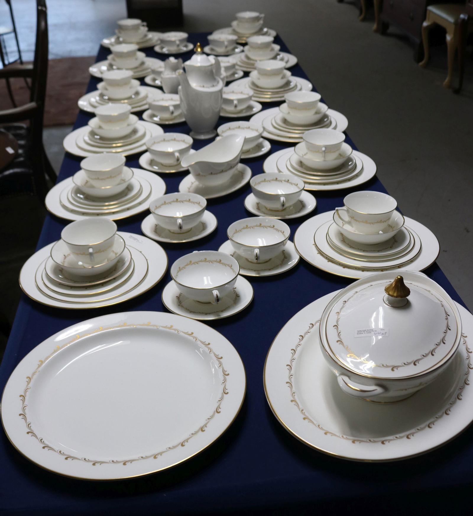 103 PCS. ROYAL DAULTON DINNER SET FOR 12, "RONDO": PATTERN, (12) 10 1/2" DINNER PLATES, (12) 8" LUNCHEON PLATES, HANDLED SOUPS 5 3/4" W, 12 CUPS 4 1/2" W 1 WITH SMALL CHIP TO BASE, 12 1/4" X 16" PLATTER, 13 1/4" DIA. ROUND PLATES, COVERED TUREEN 6 1/2