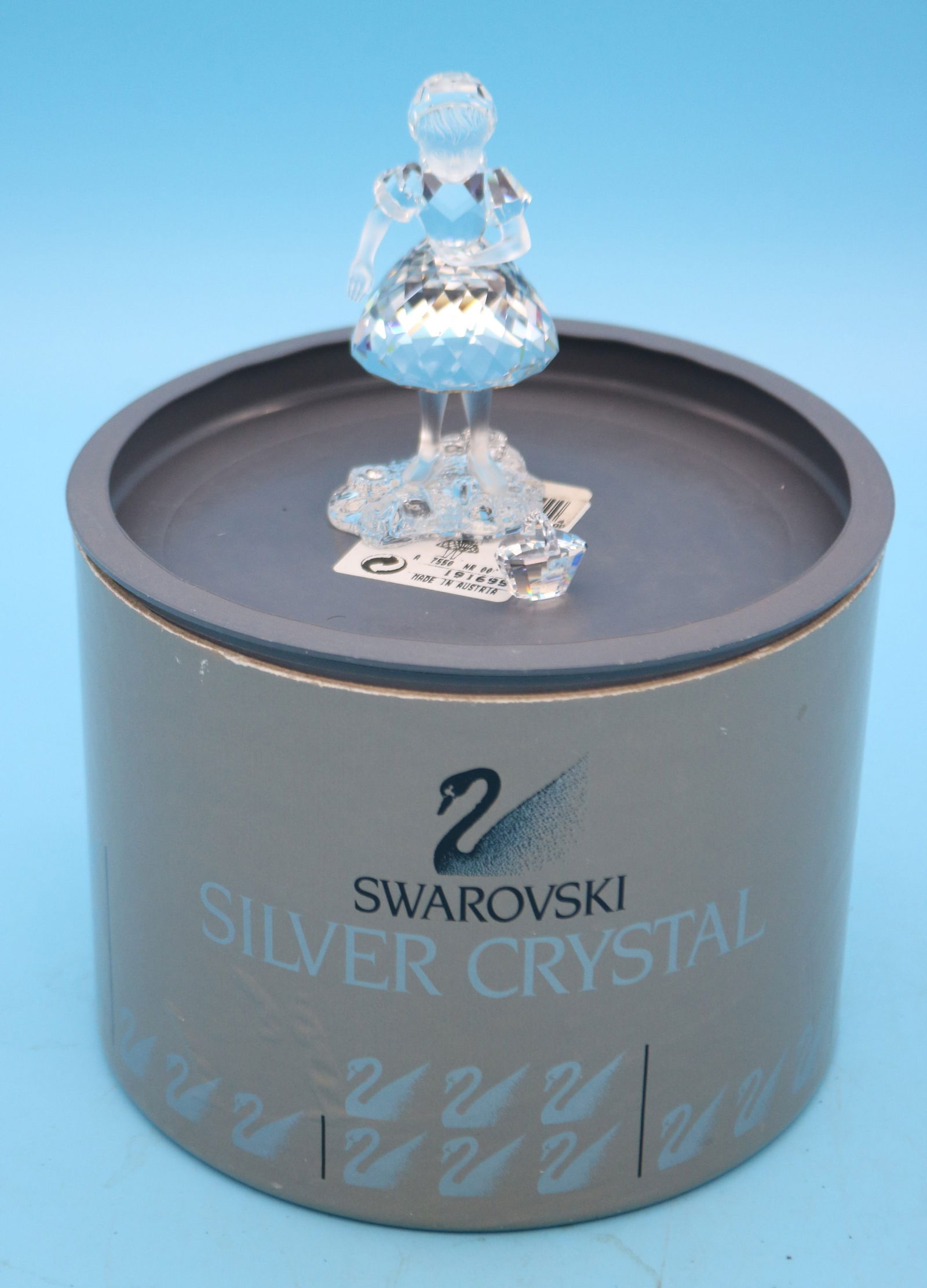 SWAROVSKI CRYSTAL FIGURE IN ORIGINAL CONTAINER,: GIRL WITH BASKET, 1/2" H - 3 1/2" H, 3/4" - 2" W