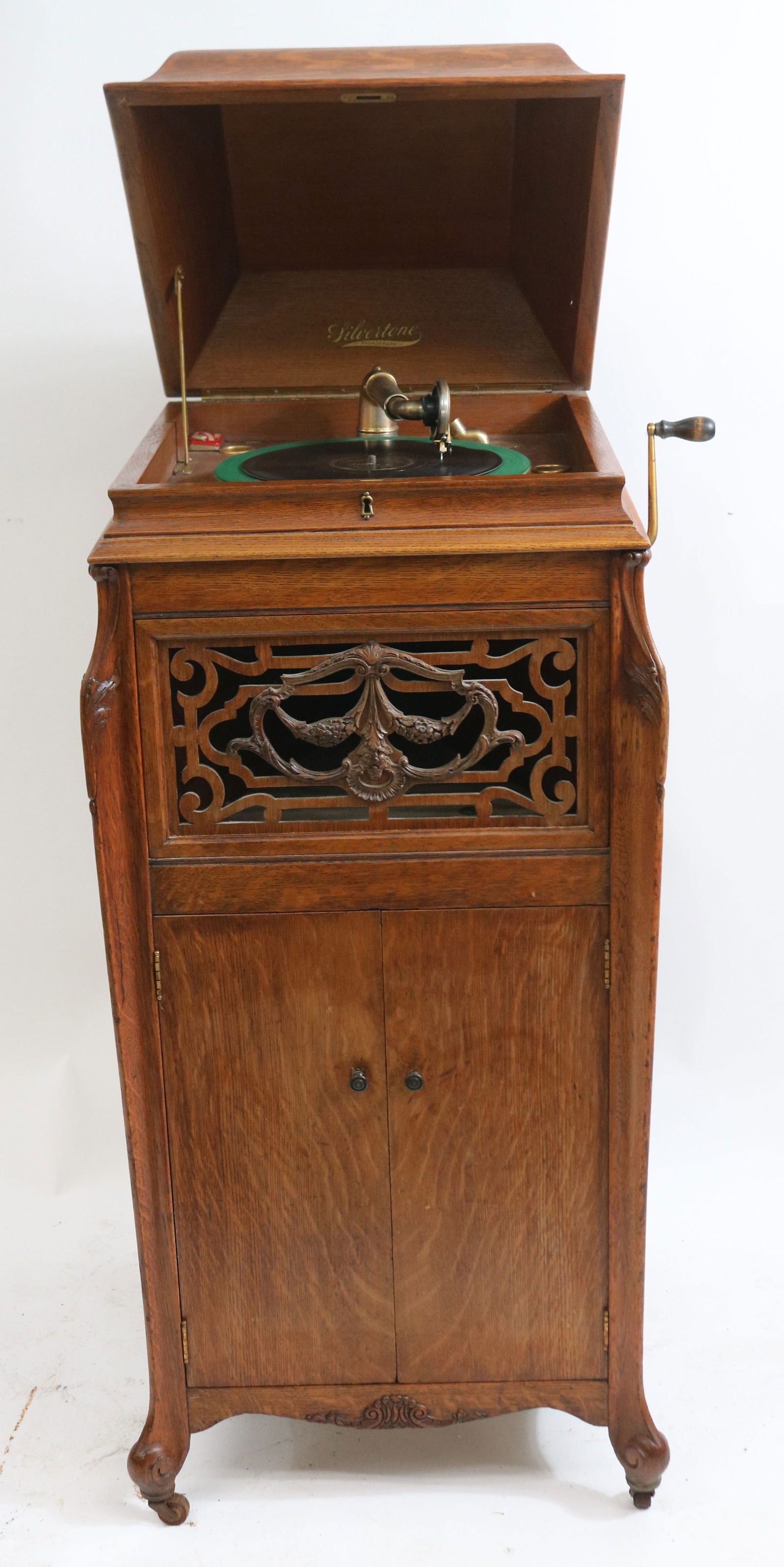 OAK SILVERTONE STANDING PHONOGRAPHY, ORNATE: GRILL, WORKING, HEAD SHOWS SOME DAMAGE, 47" H, 22" W, 22" D, OLD REFINISHED CONDITION