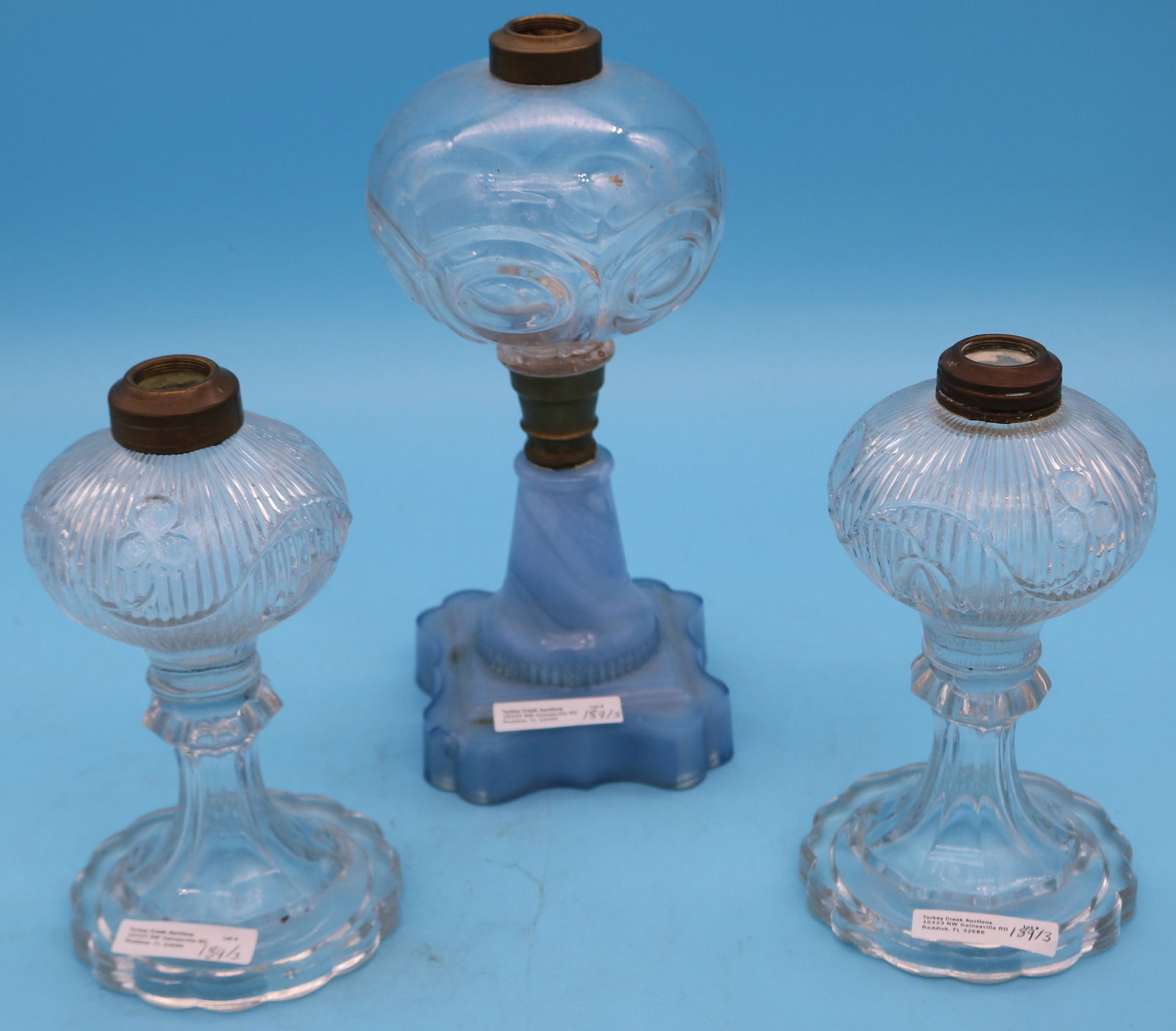 THREE 19TH C. FLUID LAMPS, PAIR BELLFLOWER FLINT: GLASS LAMPS, 7 1/2" H, 1 WITH NICK TO BASE & BULLS EYE LAMP WITH UNUSUAL BASE 10" H