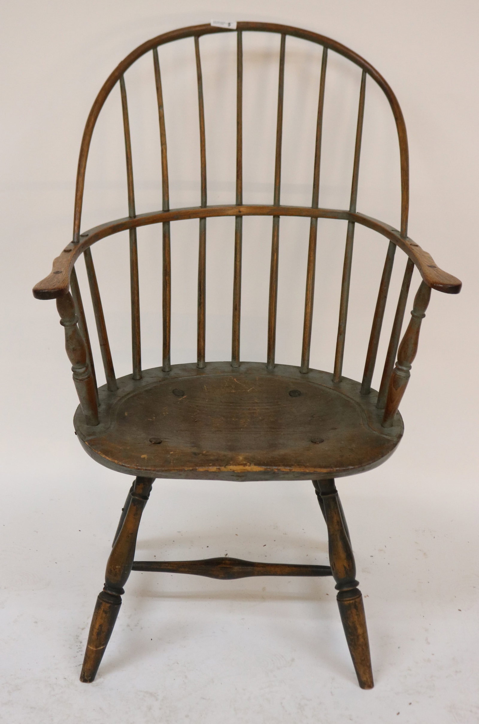18TH C. WINDSOR BOW BACK ARM CHAIR, TRACES OF OLD: PAINT, ARM SHOWS CRACK, BOLD TURNED LEGS, 39" H, 24 1/2" W, 16" D, 16" SEAT HEIGHT