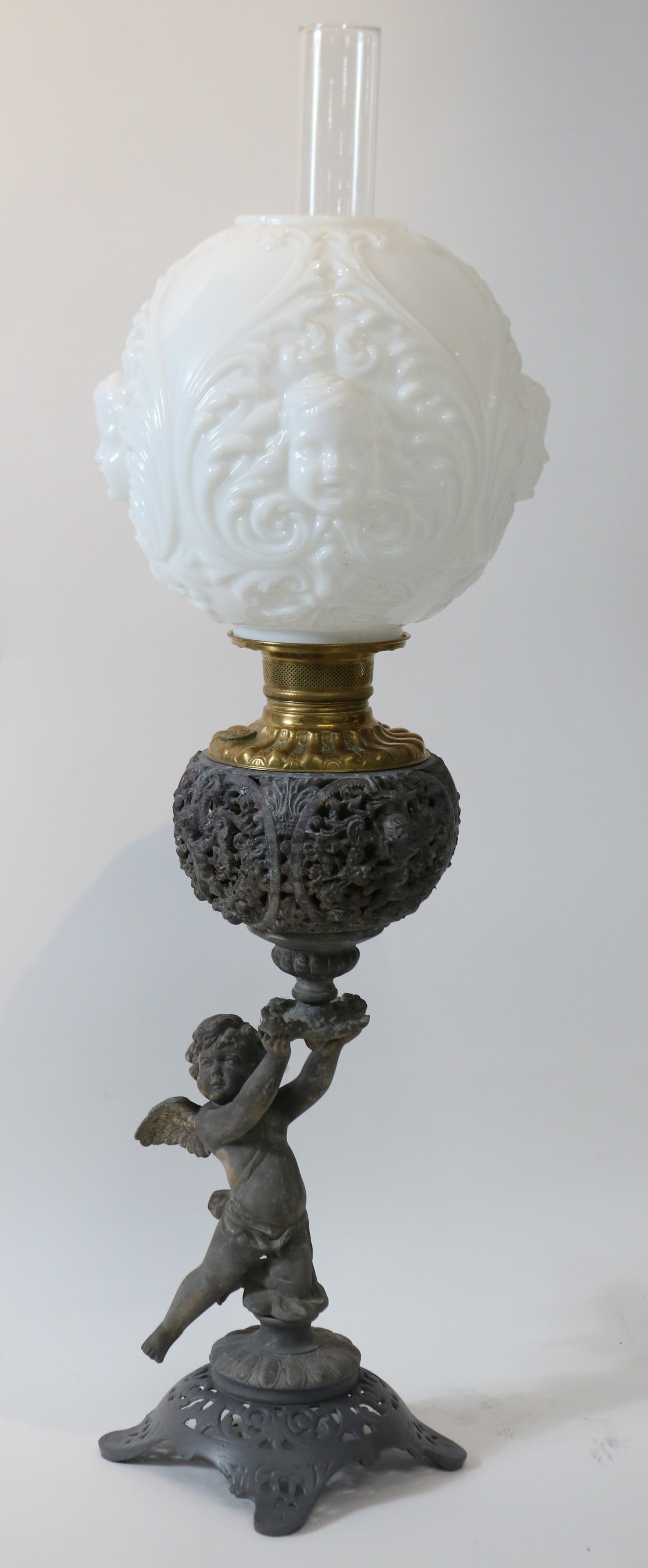 VICTORIAN FIGURAL BANQUET LAMP WITH WINGED: CHERUB, BRASS FONT, EMBOSSED MILK GLASS BALL SHADE, WORN FINISH, 30 1/2" H, 10" DIA. SHADE