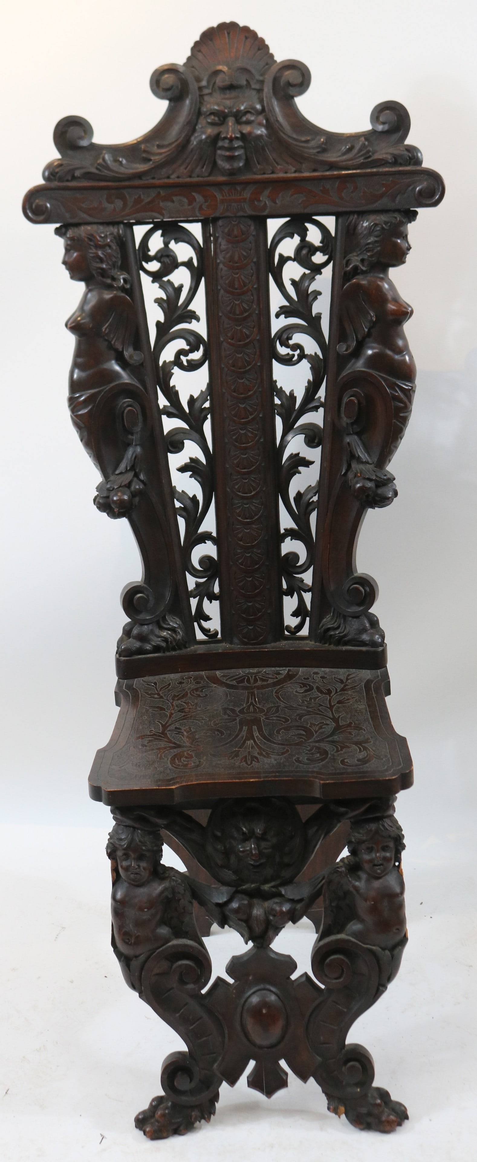 ORNATELY CARVED SGABELLO STYLE SIDE CHAIR,: WALNUT, ORIGINAL FINISH, PROBABLY ITALIAN, MISSING SOME CARVING AT BASE, 54 1/4" X 22 1/4" W, 22" D