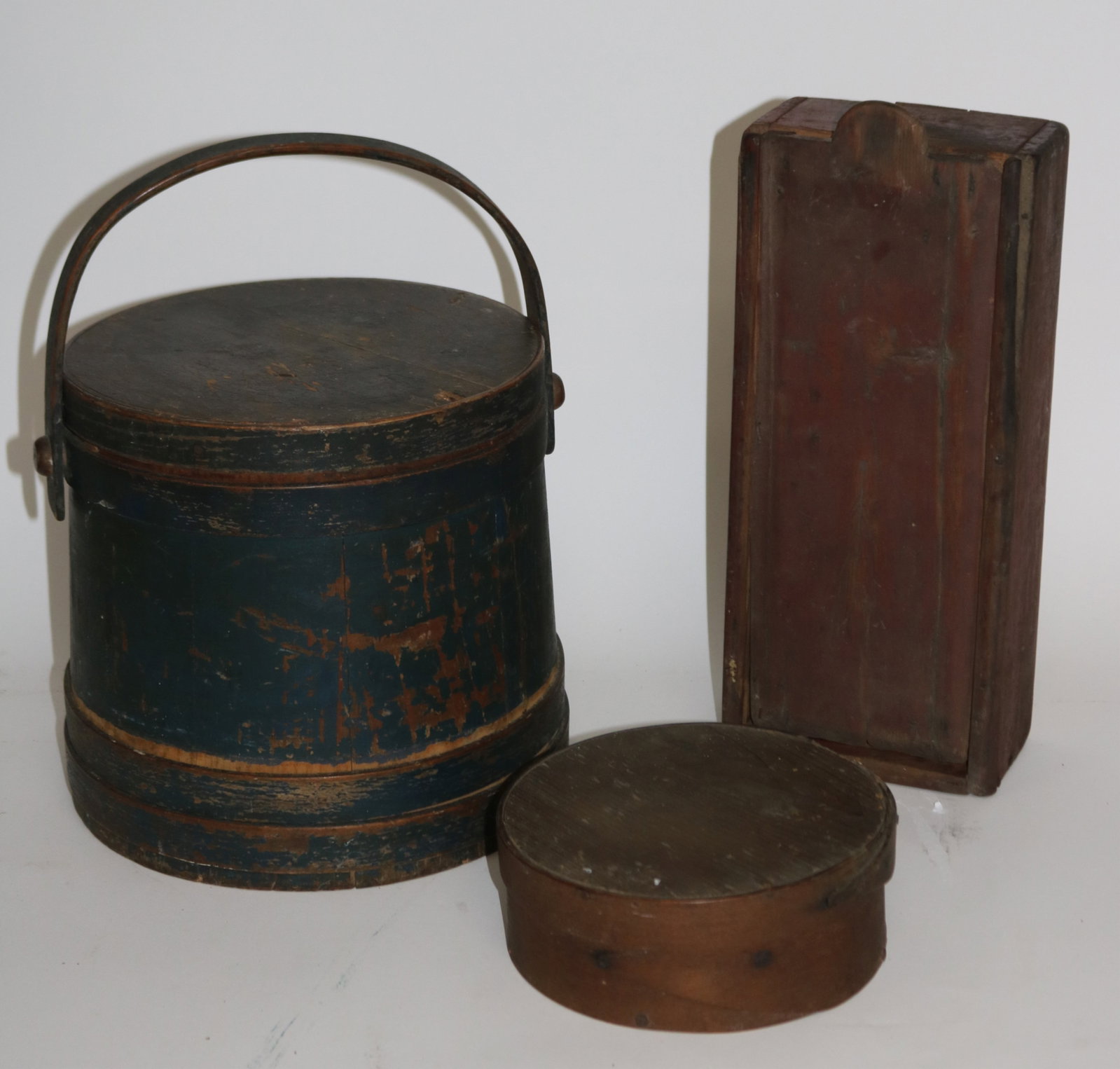 LOT 3 WOODEN PRIMITIVES, FURKIN IN OLD BLUE GREEN: PAINT, 9 1/2" H, 10" DIA., 4 1/2" HANDLE, PANTRY BOX, 2 3/4" H, 7 1/4" DIA. SLIDE LID BOX OLD RED STAIN FINISH, 14 1/4" H, 5 3/4" W, 3 1/2" D