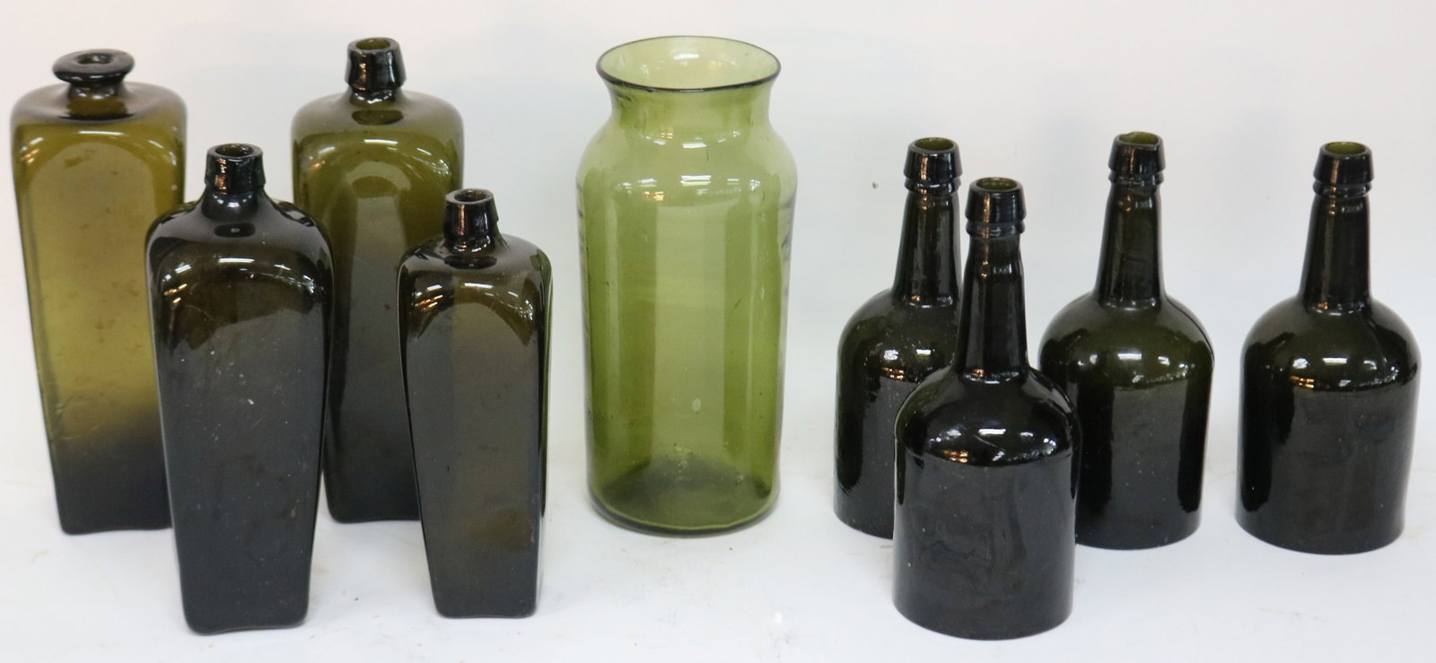 COLLECTION OF NINE 19TH C. BLOWN GLASS BOTTLES,: SHADE OF GREEN, 9 1/4" - 11 1/2" H, I CASE GIN HAS CRACK