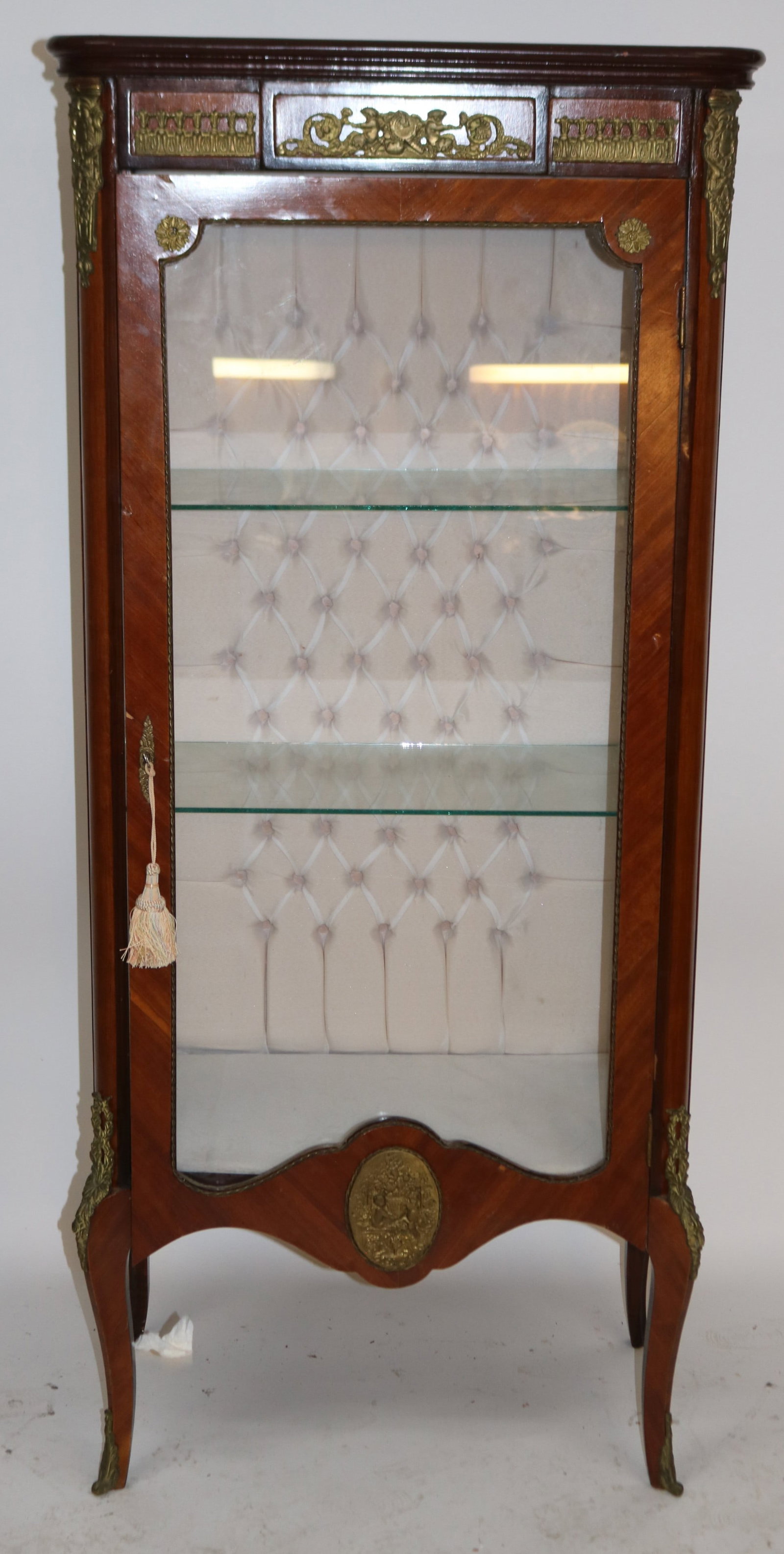 CUSTOM FRENCH STYLE CURIO CABINET, ORMOLU TRIM,: QUILTED FABRIC INTERIOR, GLASS SHELVES, LIGHT, SLIGHT VENEER BUBBLE, LOCK NUT WORKING, 63 1/4" H, 27 1/2" W, 16" D