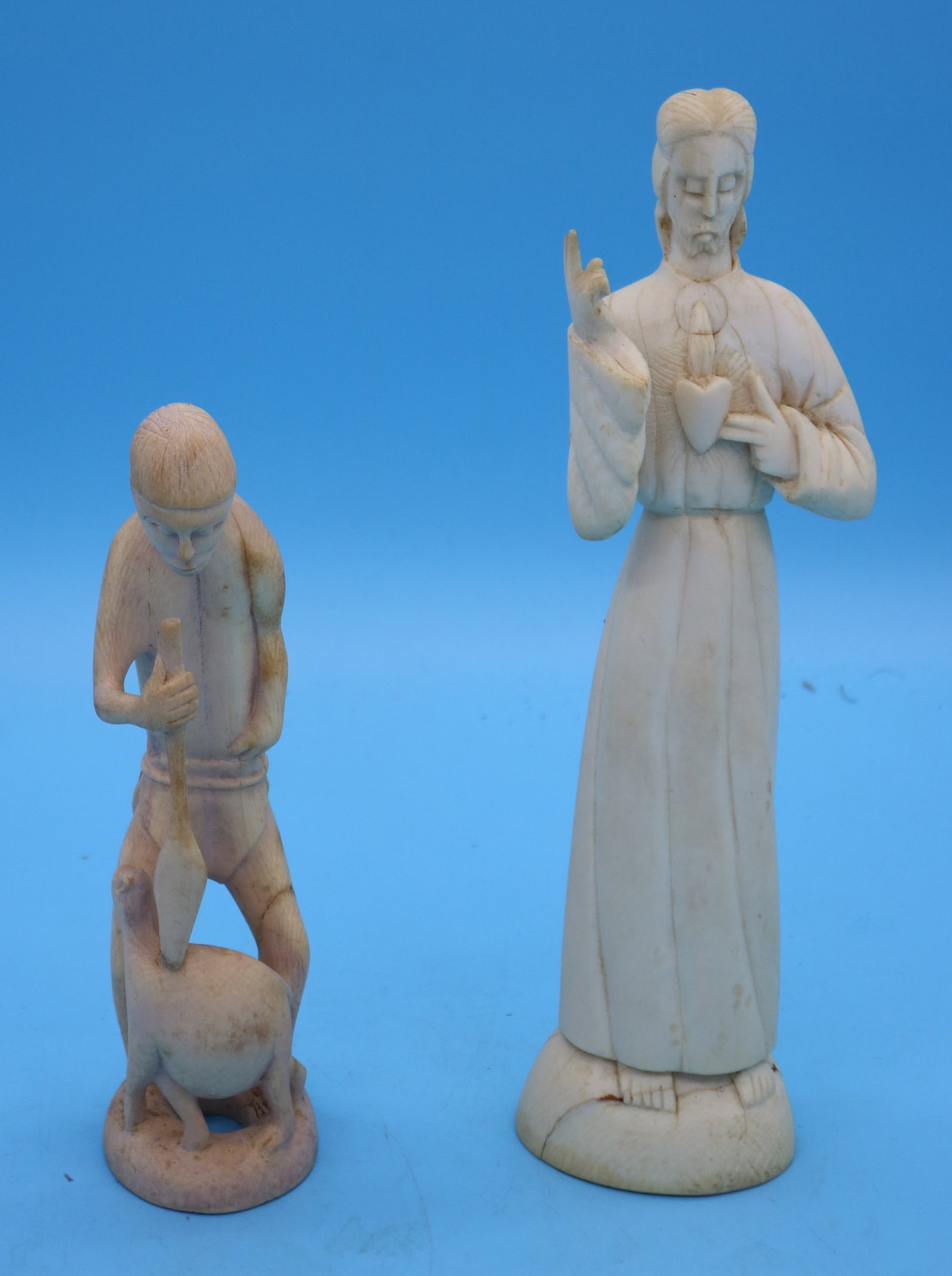 2 CARVED BONE FIGURES, JESUS & PRIMITIVE MAN WITH: ANIMAL, 11 1/2" & 8 1/2" H, FLORIDA RESIDENTS ONLY