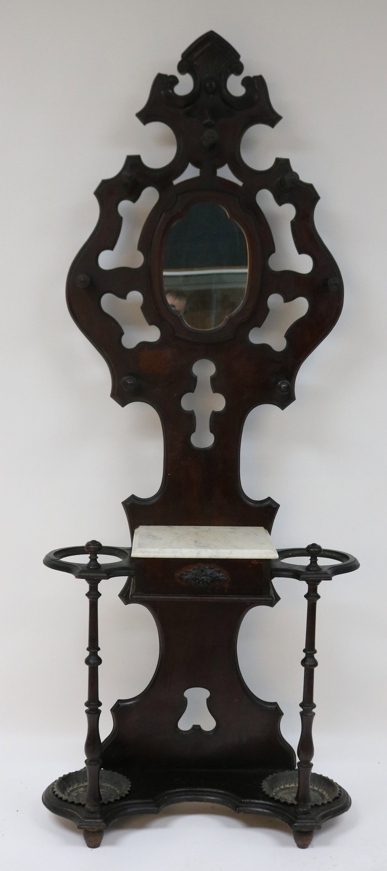 ORNATE VICTORIAN WALNUT HALL TREE, OLD FINISH,: CARVED CREST, TURNED HOOKS, MIRROR BACK, MARBLE TOP, 1 DRAWER WITH CARVED PULL, TURNED SUPPORTS, ORIGINAL IRON PANS, 88" H, 35" W, 13" D