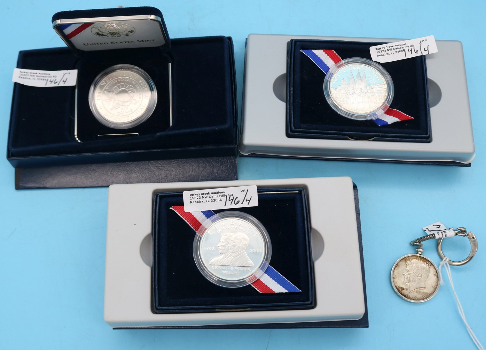 4 C.S. SILVER COINS, 3 COMMEMORATIVE SILVER: DOLLARS, TWO 20022, WEST POINT, 2003P WILBUR & ORVILLE WRIGHT, 1964 KENNEDY HALF SET INTO KEY RIN,