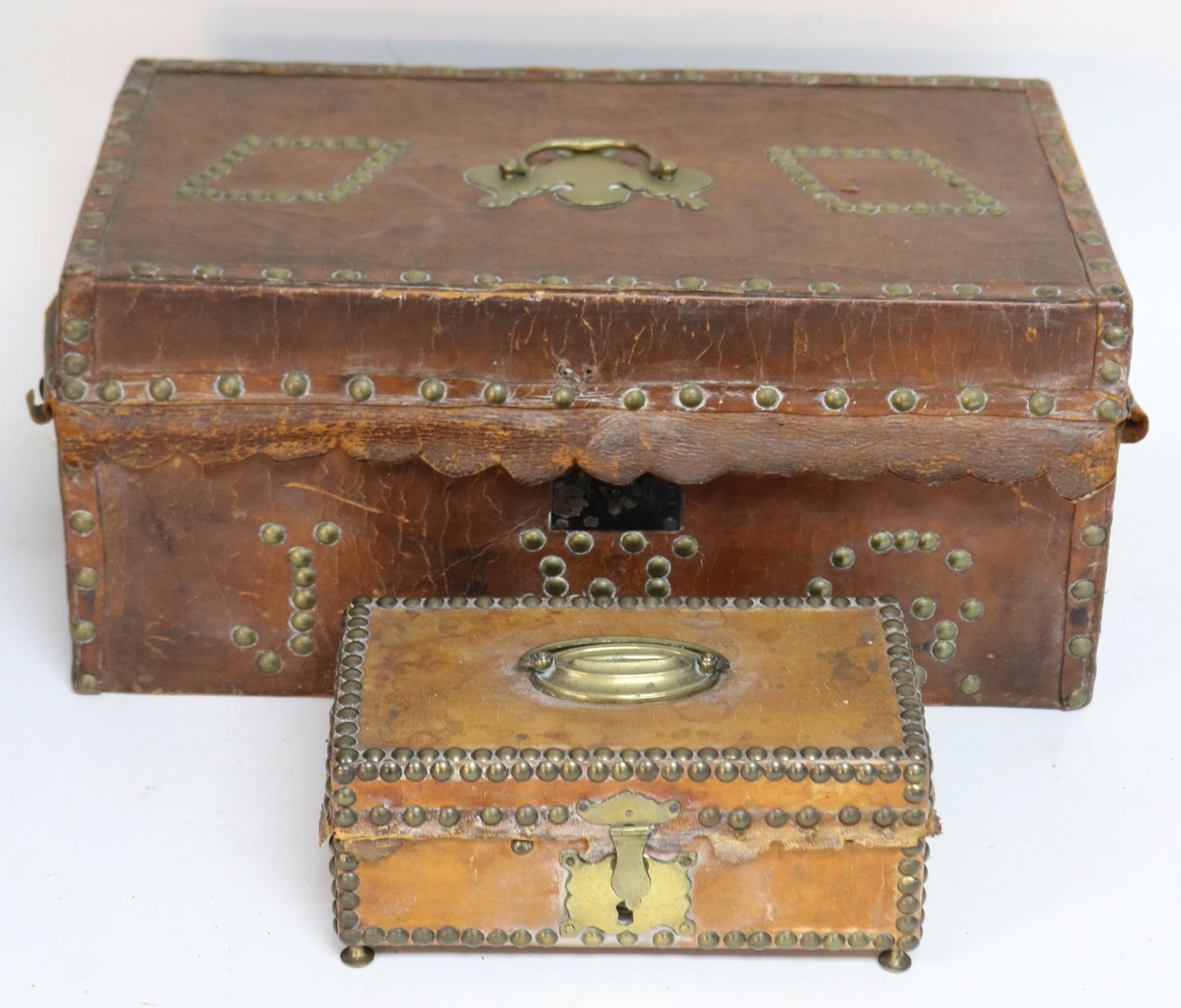 TWO 19TH C. LEATHER COVERED BOXES, BRASS STUDDED: DECORATION, ONE 3 1/2" H, 8" W, 4 1/2" D, OTHER 7" H, 16" W, 8 3/4" D, TEAR TO LEATHER