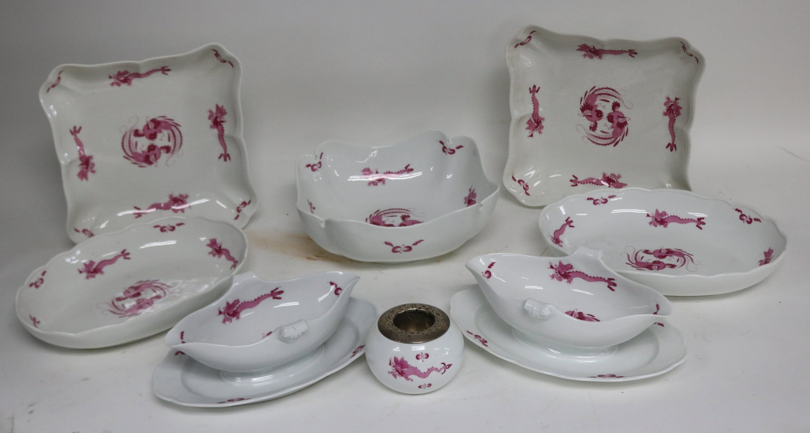 8 MEISSEN PORCELAIN SERVING PCS., BLUE CROSS: SWORD MARK, PINK COURT DRAGON PATTERNS, 2 SQUARE SERVING DISHES, 1 7/8" H, 9 1/4" X 9 1/2" OVAL SERVING DISHES, 2" H, 11" W, 7 3/8" D, FRUIT BOWL 3 1/2" H, 8 3/4" X 9 1/4", 2 GRAVY BOATS, 3 1/2" H, 10